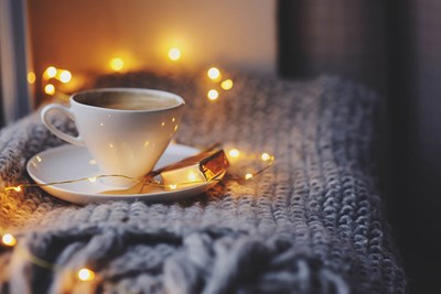 Hot cup of cocoa on a fluffy, warm blanket.