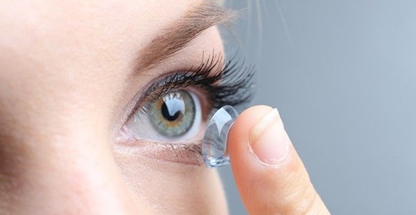 Close up of a woman putting a contact in her eye