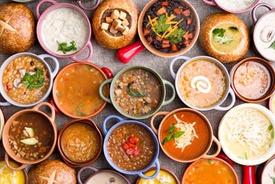 flat lay of different soups in bowls