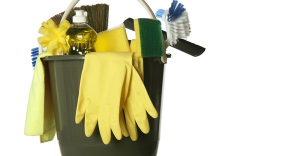 a cleaning bucket filled with cleaning supplies, gloves, and brushes