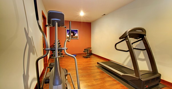 a home gym with treadmill, elliptical,and free weights