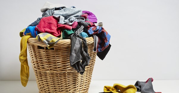 an overflowing laundry basket that needs to be sorted