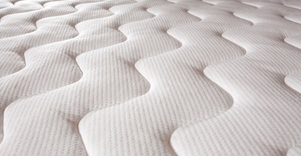 a close up of a pattern sewn into a mattress