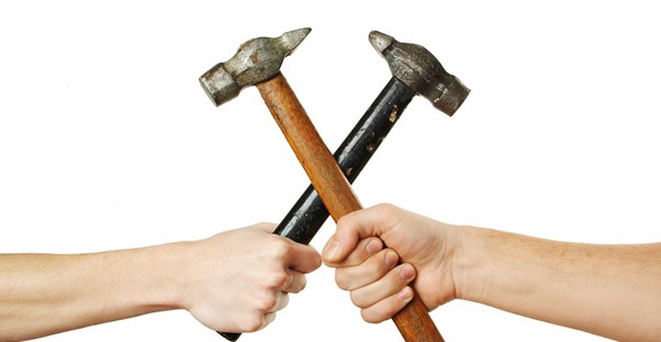two people holding crossed hammers
