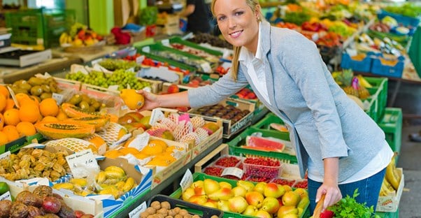 Woman chopping organic produce on a budget