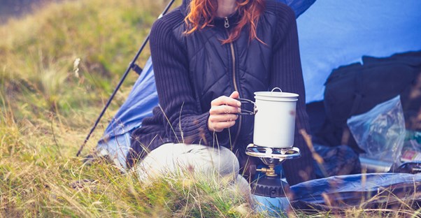 Woman using survival tips to enjoy her camping trip