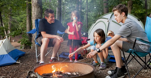 A family practicing camp fire saefty