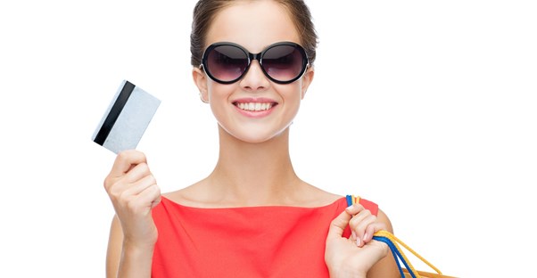 Woman smiling as she uses her credit card to holiday shop