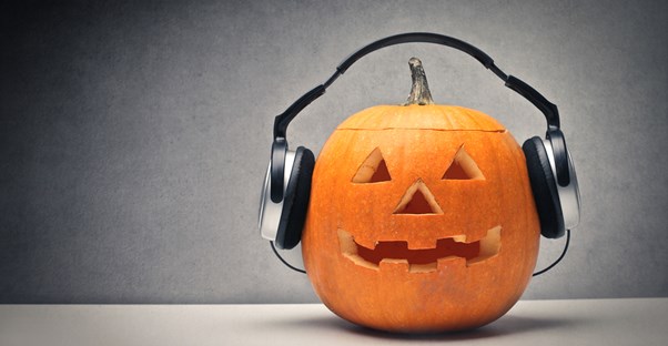 A jack-o-lantern listening to a halloween playlist