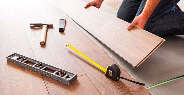 A man installing a wood floor