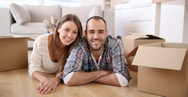 Couple Smiling in their new home because they had a smooth move