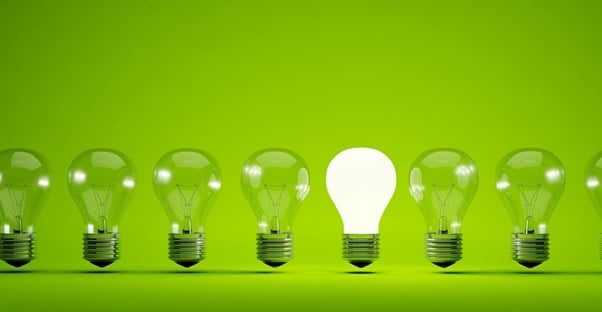 A row of light bulbs on a green background.