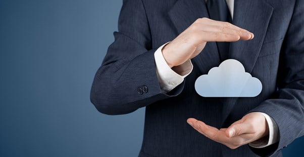 A man in a business suit holding a digital cloud image.