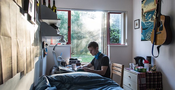 A college student in his dorm room.