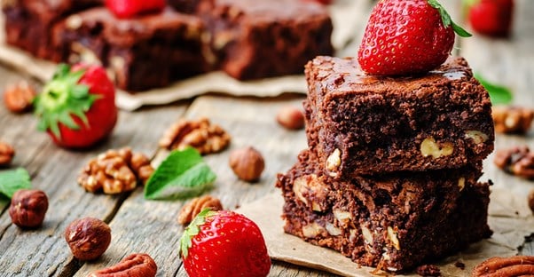 A brownie with nuts and strawberries