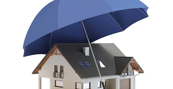 Umbrella covering a house representing umbrella insurance