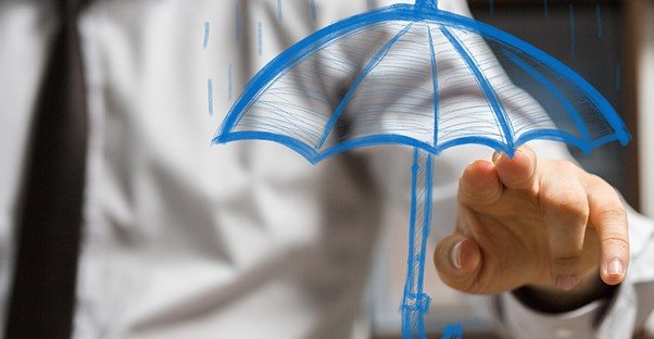 a man pointing at a drawn picture of an umbrella to explain what professional liability insurance is and what it protects