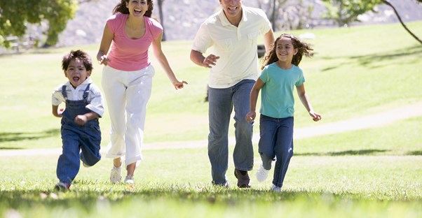Family running through a park