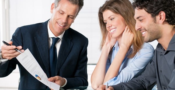 Insurance agent goes over the details with a young couple