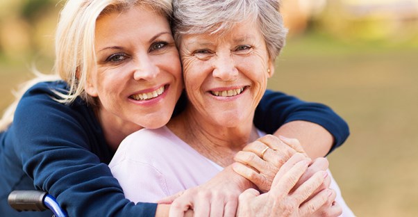 Woman with long term care insurance hugging her daughter