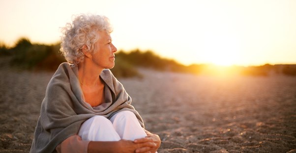 Woman looking off into the distance, contemplating long term care insurance