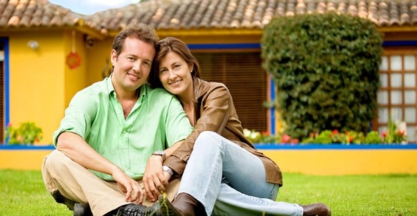 A happy couple discussing how to buy homeowners insurance