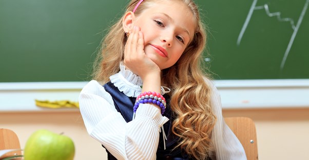 A young student wears a school uniform to school