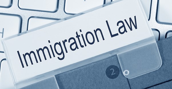 Tab that says immigration law on top of a keyboard