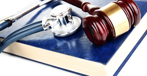 A gavel and a stethoscope laying on a legal book to represent the idea of accident injury lawyers