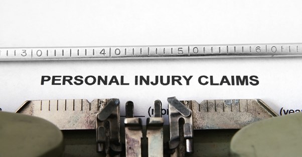 Personal Injury Claims typed on a piece of paper in a typewriter to display the seriousness of these claims and support hiring accident injury lawyers