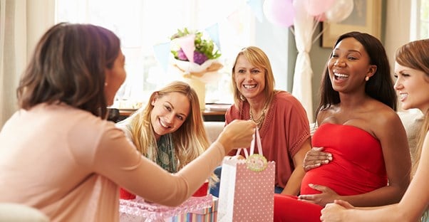mom opening gifts at baby shower