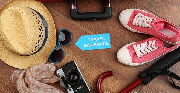 travel insurance with items packed for vacation