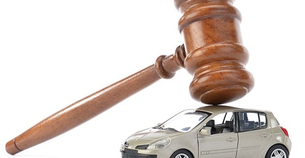 a gavel resting on a toy car showing that cars from auctions are a risk vs. reward