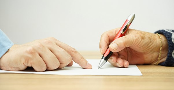a man and a tax professional signing inheritance law paperwork