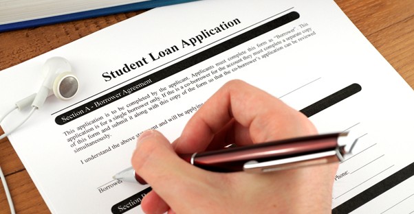 Student signing a student loan agreement