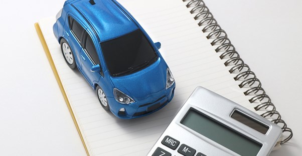 Car, calculator, and notepad. Cost of Living.