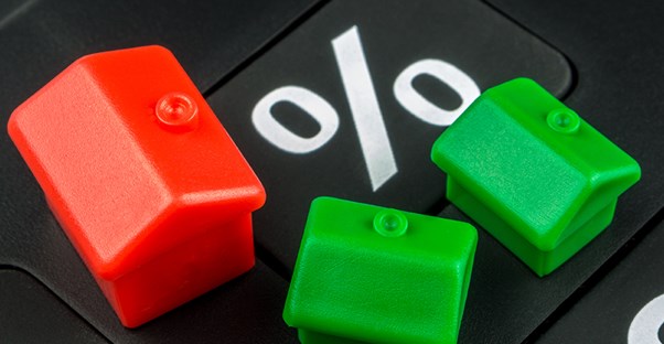 Toy houses and percentage sign. Types of home loan mortgage rates.