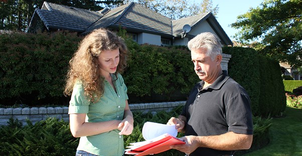 Man and woman looking over contract. Home Inspection.