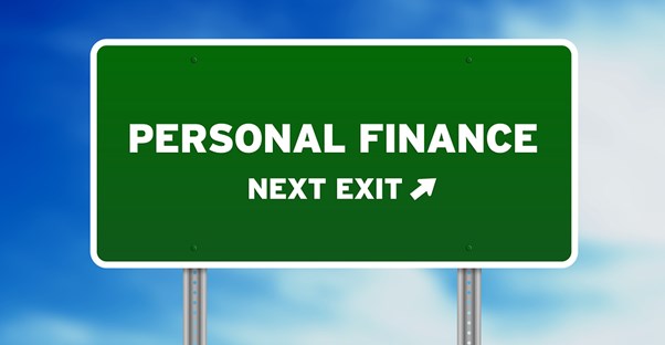 a green interstate exit sign titled personal finance