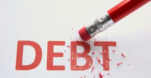 an eraser eliminating the word debt as a visual representation of debt management