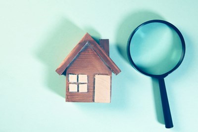 a house and a magnifying glass symbolizing a not very well known mortage clause