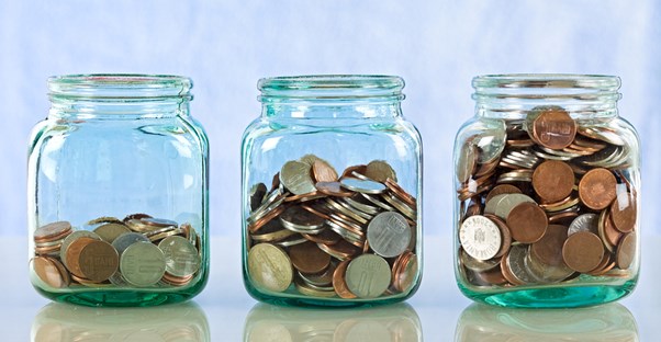 Three jars filled with varying amounts of coins to represent the three kinds of savings accounts.