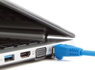 An Ethernet cable plugged into a computer using service from a ranked internet provider.