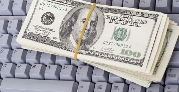 Bundle of 100 dollar bills on a keyboard