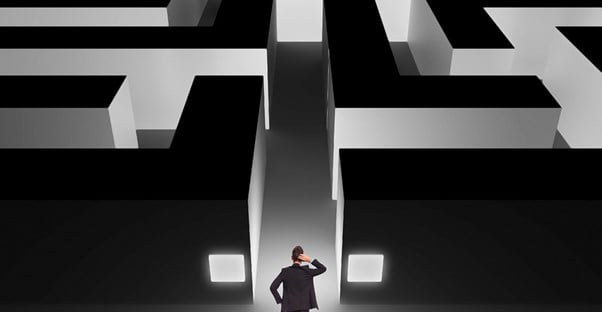 Man standing at the entrance of a maze of risks