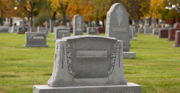 A large headstone in a cemetery