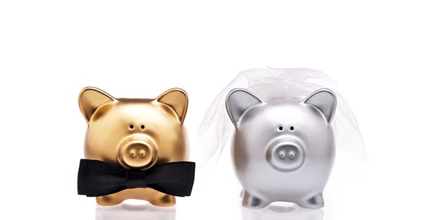 Two piggy banks dressed up for a wedding