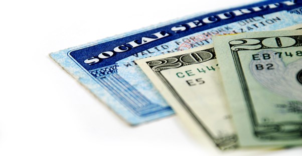 Social security card underneath 2 twenty dollar bills