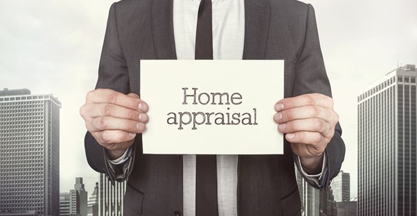 Real Estate Appraiser holding a sign that says Home Appraisal