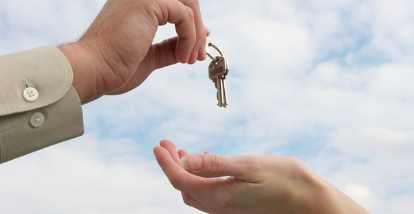 Real estate agent hands over the keys to a new home